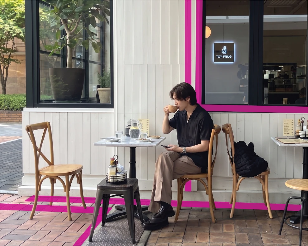 Person enjoying coffee at an outdoor café